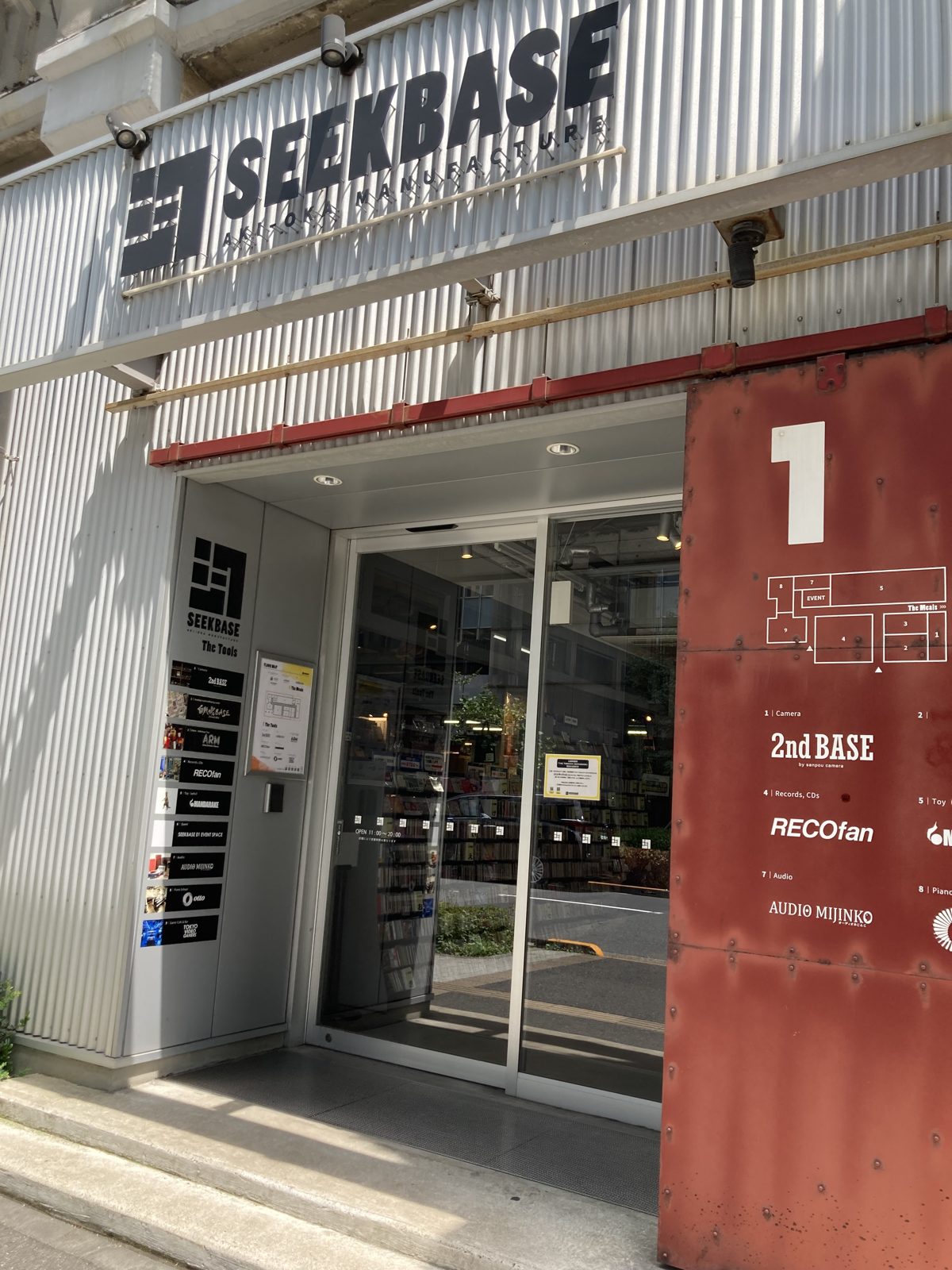 Entrance of SEEKBASE in Akihabara, with an English floor guide listing 2nd BASE by sanpou camera