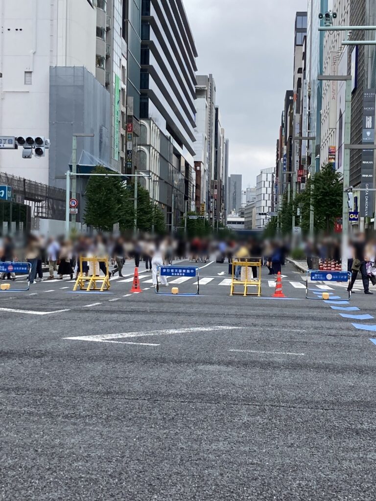 Ginza main street closed to cars as a pedestrian zone, with barricades and a Pedestrian Paradise sign