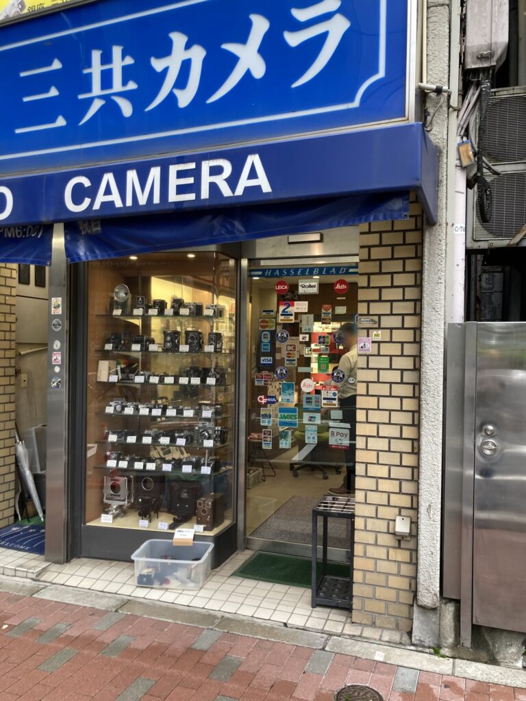 Sankyo Camera show window of twin-lens reflex and classic cameras, with Hasselblad, Leica and Rollei stickers on the door