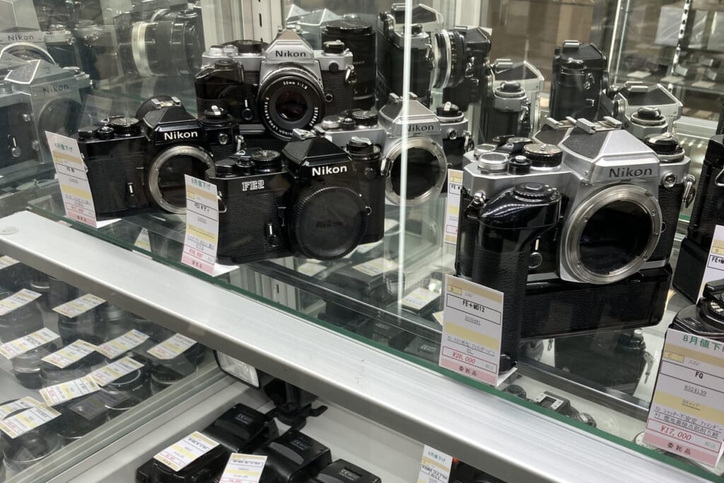 Nikon film SLR cameras with price tags of 39,000, 26,000 and 17,000 yen in a showcase at Lemon Camera Ginza